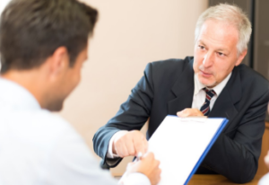 two businessmen discussing a document