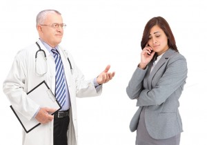 Mature doctor talking to a worried male patient, isolated on whi